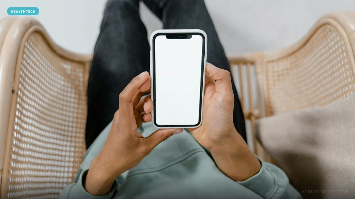 Overhead view of a person in a rattan chair holding a smartphone with a blank white screen