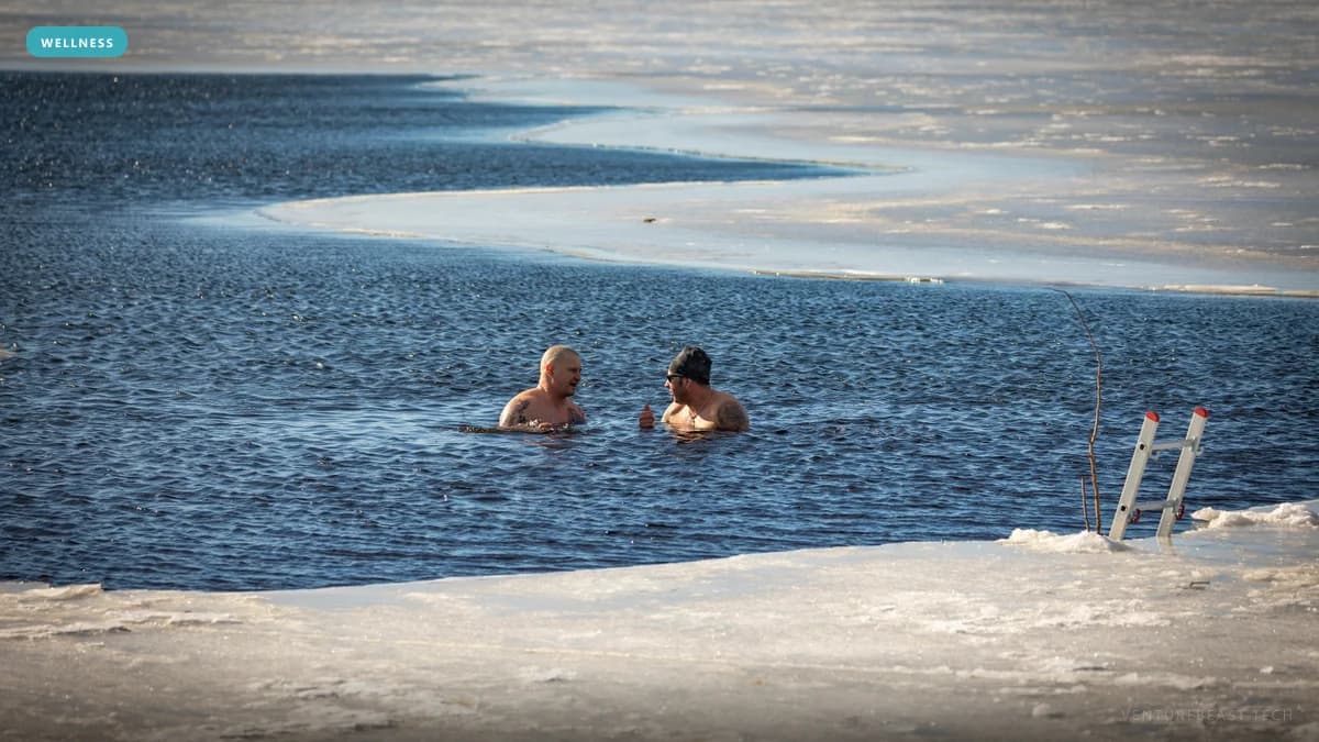 Two men swimming in an icy lake beside a hole cut in the ice with a metal ladder