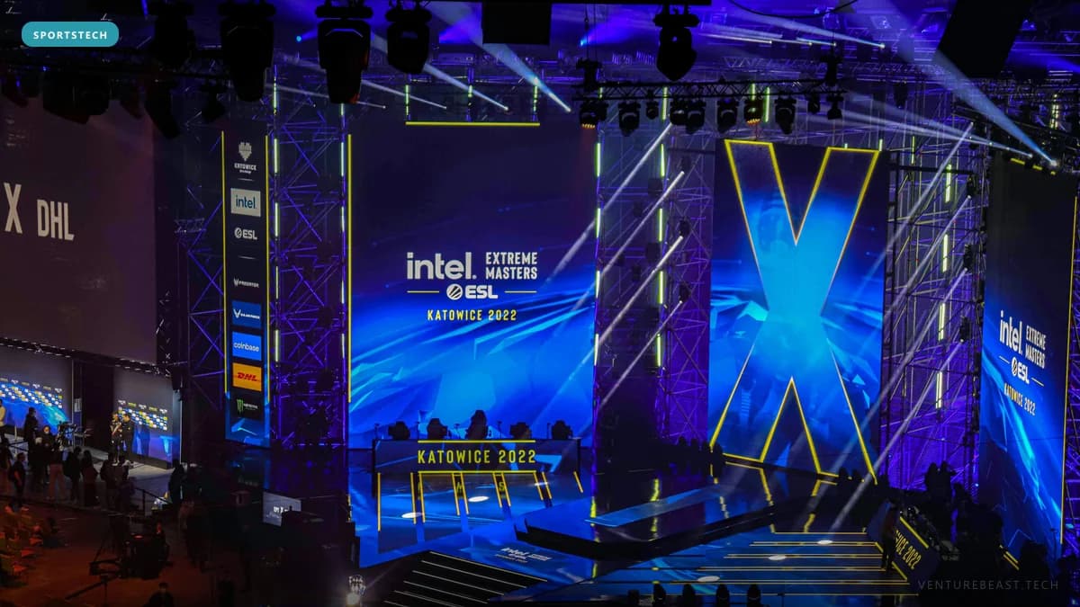 Esports arena stage lit in blue with Intel Extreme Masters ESL Katowice 2022 screens and lighting rigs
