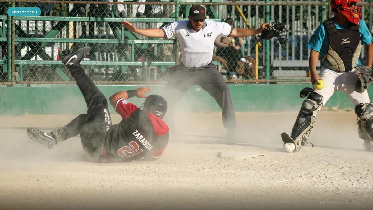 A baseball runner sliding into home plate in a cloud of dust as the umpire signals safe and the catcher holds the ball